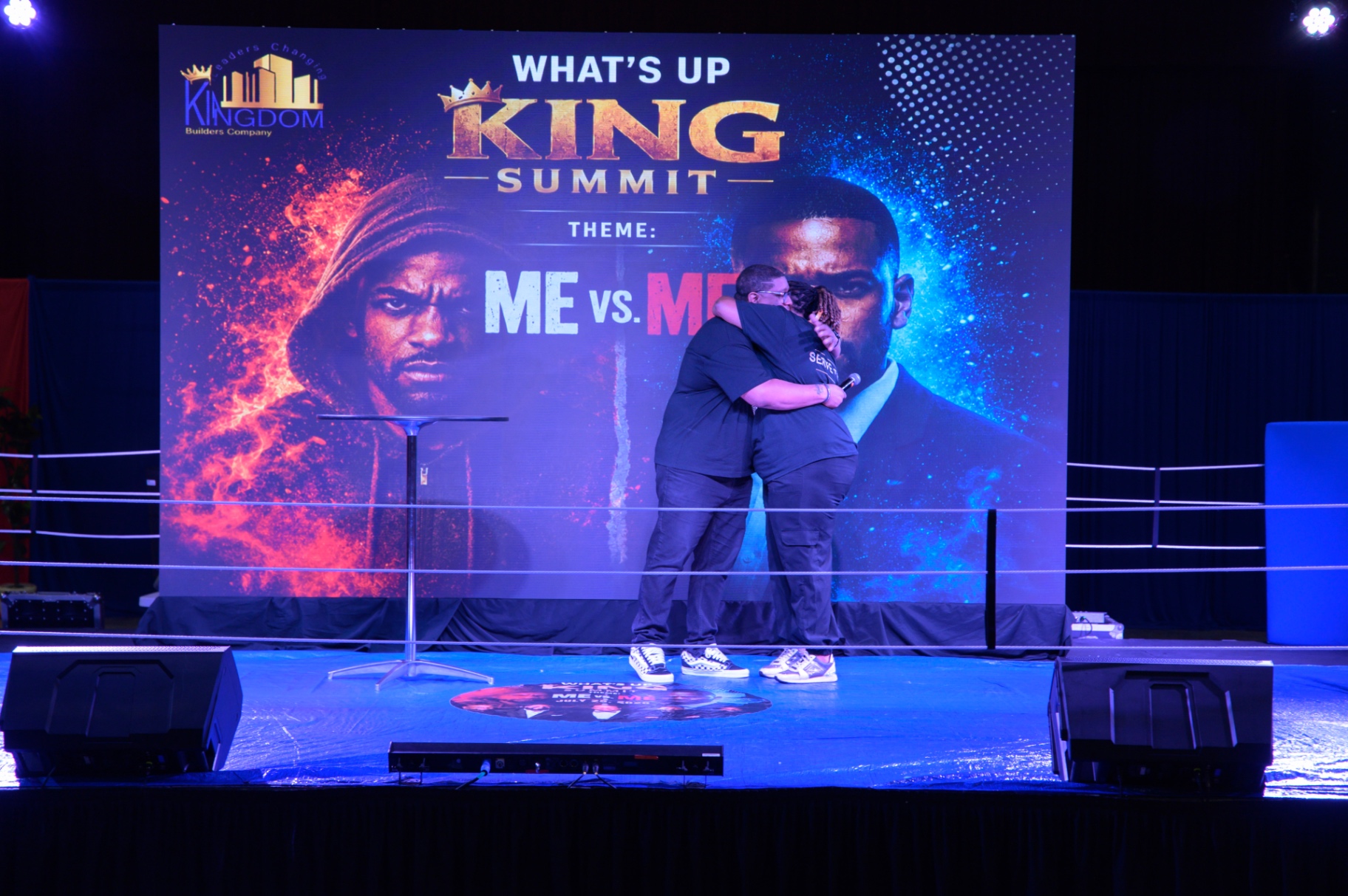 An emotional embrace on stage during the What's Up King Men's Summit