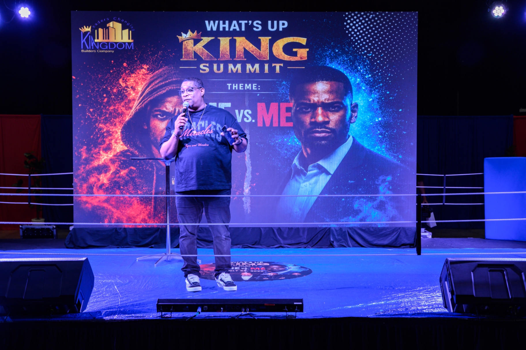 Two men standing together under the summit lights